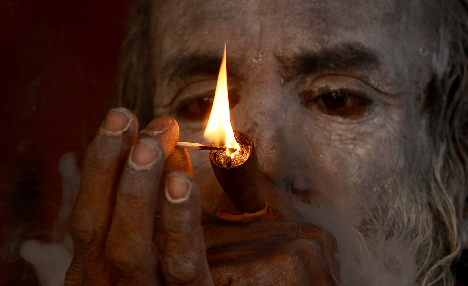 A Hindu holy man smokes cannabis at his temporary camp on Gangasagar Island, around 150 kms south of Kolkata. PHOTO: AFP