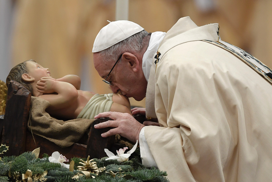 Pope Francis kisses a statue of baby Jesus as he arrives to lead a mass to celebrate the Epiphany, or 12th day of Christmas, with a mass in Saint Peter's Basilica which marks the visit to the baby Jesus by the Three Wise Men. PHOTO: AFP