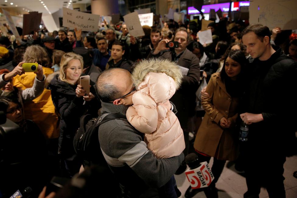 The Bay family is reunited after Hamed Bay was separated from other passengers and questioned as a result of U.S. Donald Trump's executive order travel ban, at Logan Airport in Boston, Massachusetts, U.S. January 28, 2017. Hamed Bay was traveling back to the U.S. after visiting his sick father in Iran. REUTERS/Brian Snyder