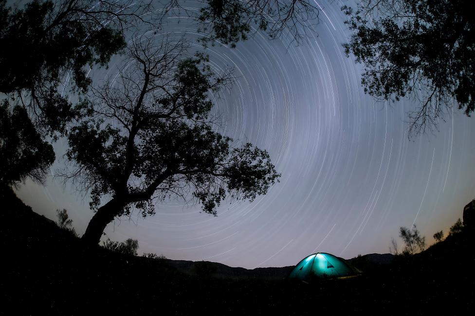 KAZAKHSTAN: A long exposure photograph shows star trails in the night sky over a camp in Altyn-Emel national park, in Almaty region, Kazakhstan, May 13, 2016. REUTERS/Shamil Zhumatov