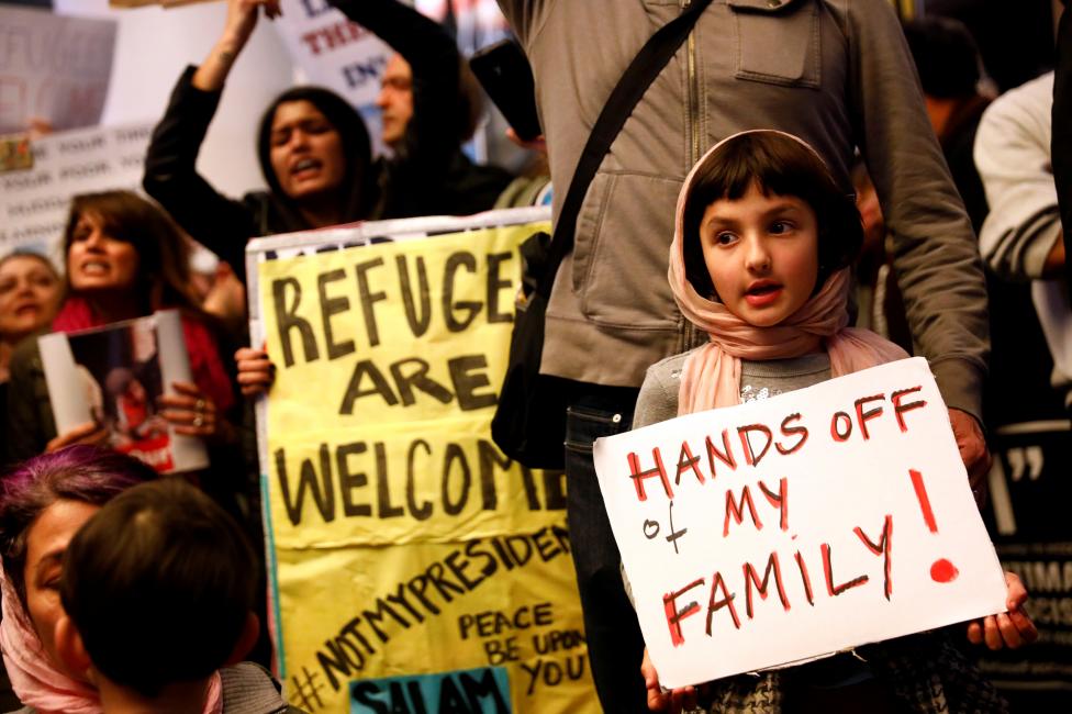 Rosalie Gurna, 9, holds a sign in support of Muslim family members as people protest against U.S. President Donald Trump's travel ban on Muslim majority countries, at the International terminal at Los Angeles International Airport (LAX). REUTERS/Patrick T. Fallon
