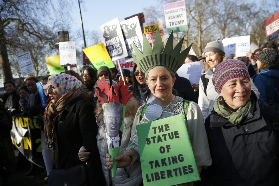 Protesters carrying banners take part in the Women's March on London, as they walk from the American Embassy to Trafalgar Square, in central London. REUTERS/Neil Hall