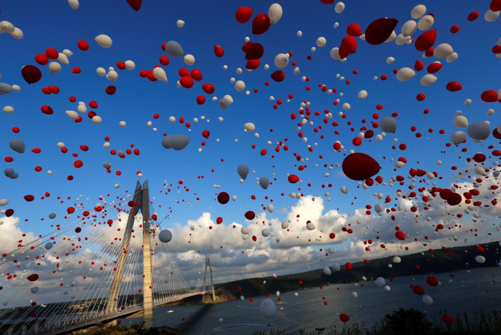 TURKEY: Red and white balloons are released during the opening ceremony of newly built Yavuz Sultan Selim bridge, the third bridge over the Bosphorus linking the city's European and Asian sides in Istanbul, Turkey, August 26, 2016. REUTERS/Murad Sezer