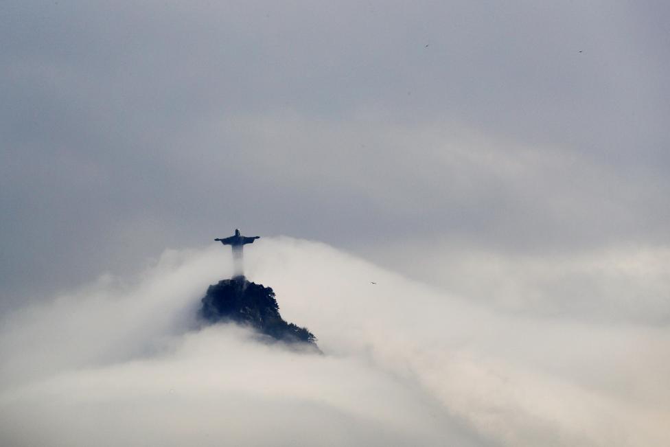 BRAZIL: Clouds surround the Christ the Redeemer statue over Rio de Janeiro, Brazil, August 9, 2016. REUTERS/Brian Snyder