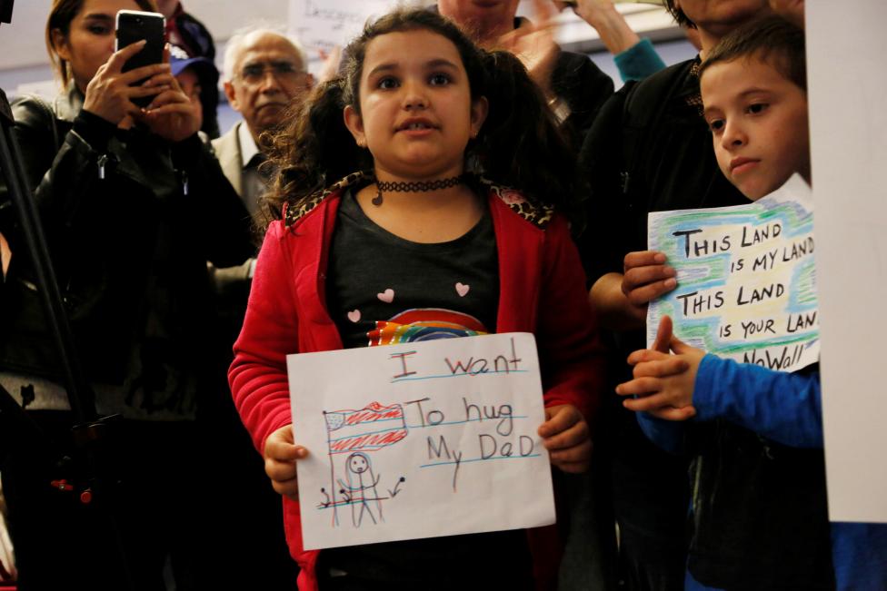Teija age 7, her father is stuck in Iran due to the travel ban, holding a sign during protest against the travel ban imposed by U.S. President Donald Trump's executive order, at Los Angeles International Airport. REUTERS/Ted Soqui