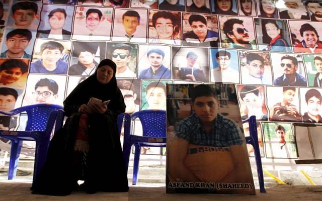 Shahana Ajoon, mother of Asfand Khan, sits beside a picture of her son in Peshawar, Pakistan December 11, 2015. PHOTO: REUTERS