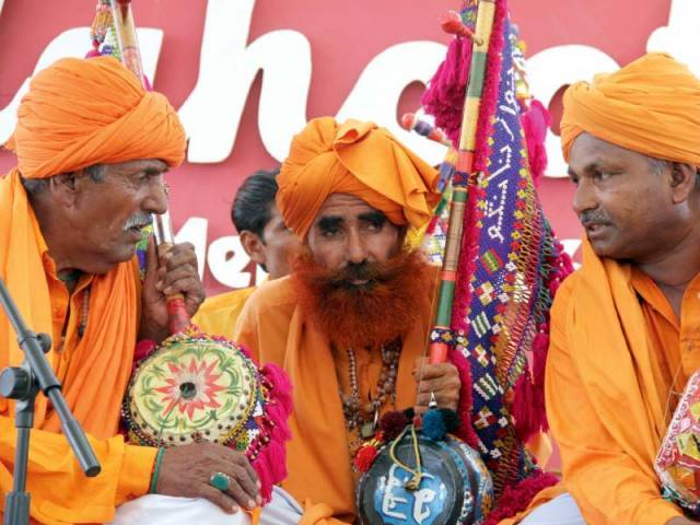 Fakir Sufi Bhura Lal and group have a discussion between performances on the second day of Lahooti Melo 2016. PHOTO: AYESHA MIR/EXPRESS
