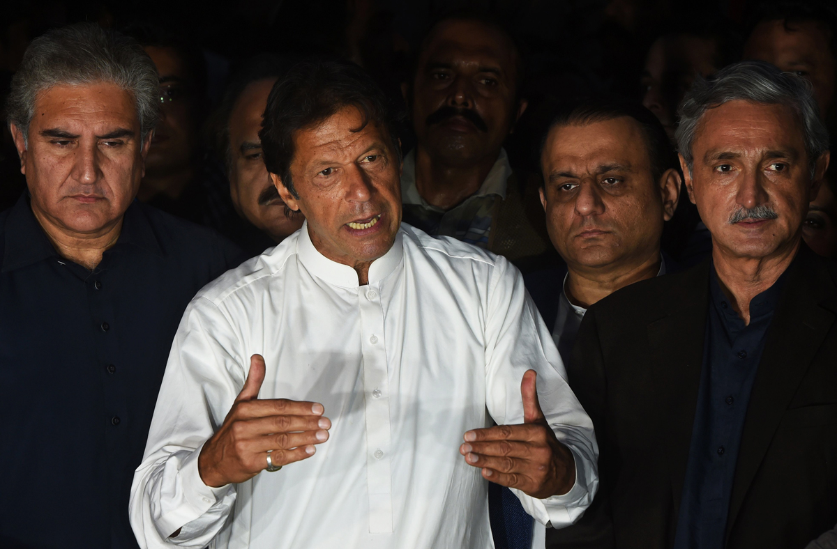 pakistani opposition leader of the tehreek i insaf pti political party imran khan c speaks during a press briefing outside his house in islamabad on october 30 2016 photo afp