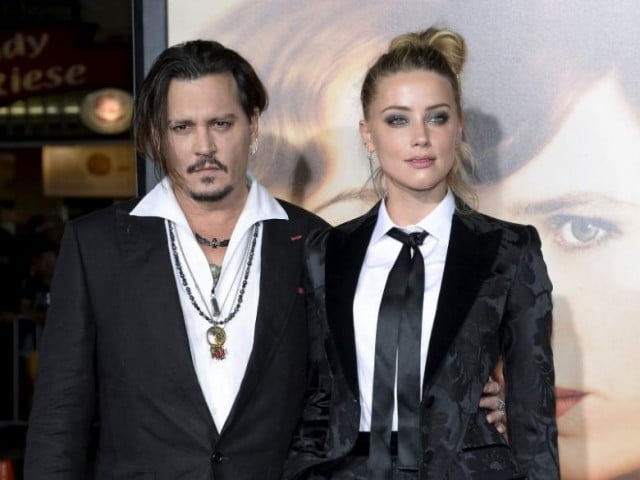 Cast member Amber Heard and husband Johnny Depp pose during the premiere of the film "The Danish Girl," in Los Angeles, California November 21, 2015. REUTERS/Kevork Djansezian/File Photo - RTX2LACU