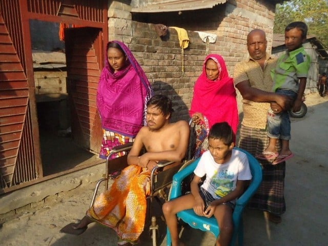 Bangladeshi father Tofazzal Hossain with his family. PHOTO: AFP
