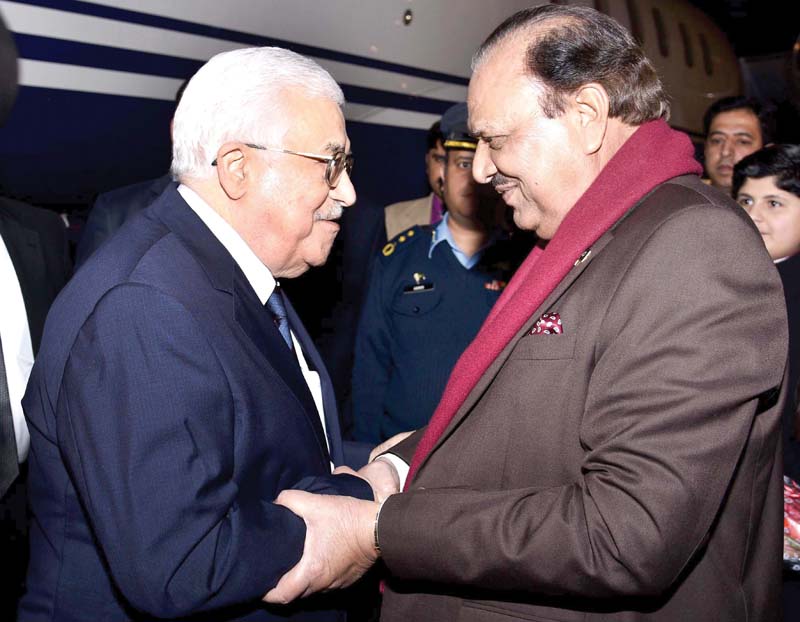 president mamnoon hussain greeting palestinian president mahmoud abbas upon his arrival at the military airbase in islamabad photo afp