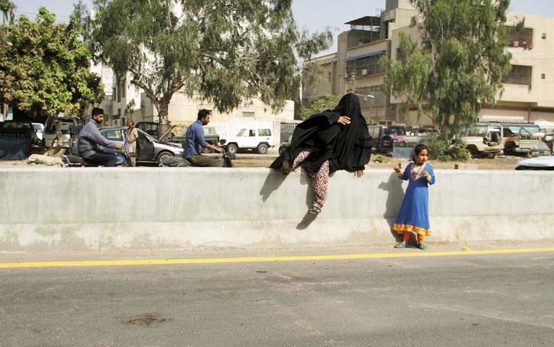 a woman and a girl find a way to cross the newly constructed sadequain underpass which was inaugurated on tuesday photo online