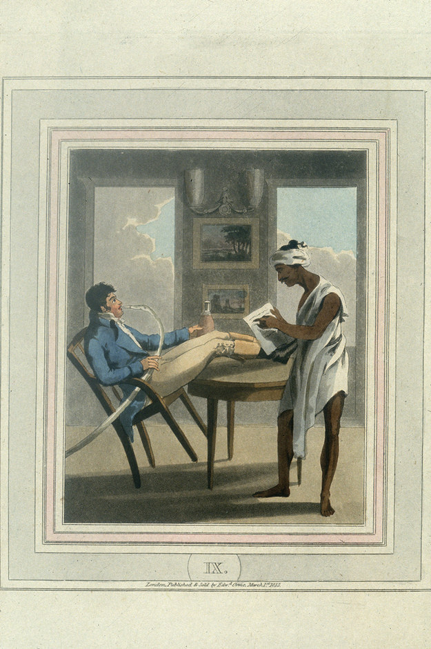 3. “A young European leans back in his chair and takes a drag on his hookah while his Indian servant reads to him.”