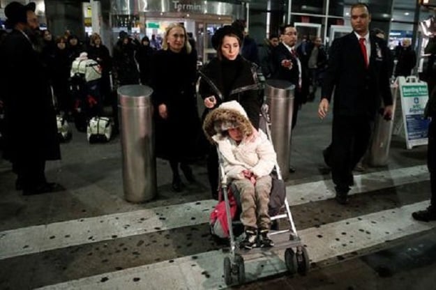 Alma Kashkooli, (12), from Iran who has a severe medical condition, is wheeled out of customs by her mother Farimeh Kashkooli who is living in the United States on a student Visa while studying at Fordham University Law School in New York, as Alma arrives at New York's John F Kennedy International Airport in New York after traveling from Istanbul Turkey February 6, 2017. PHOTO: REUTERS