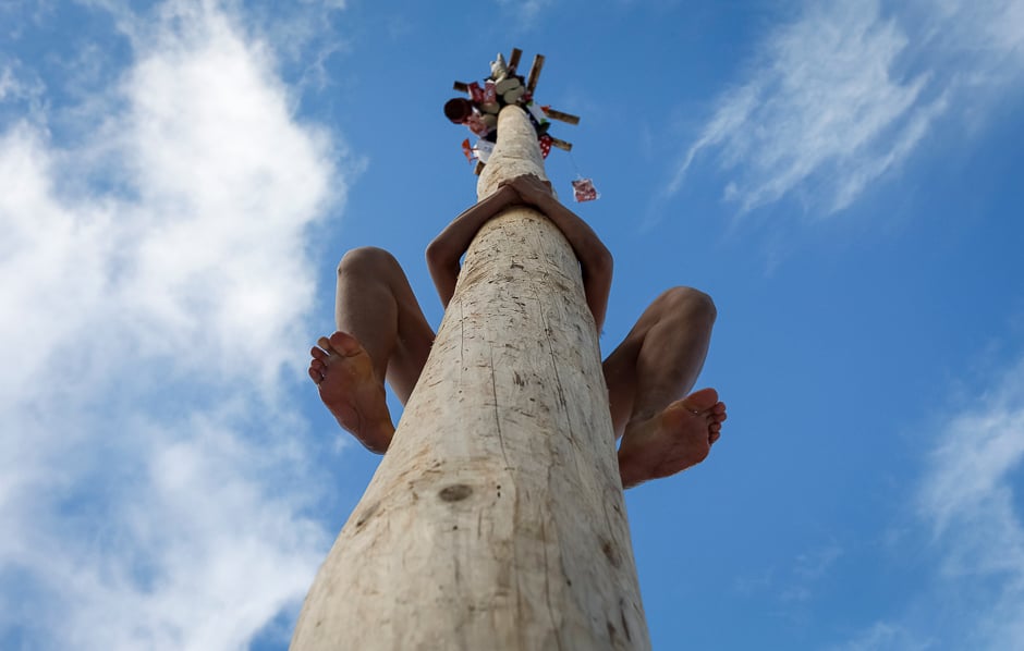 A man climbs up a wooden pole to get a prize during celebration of Maslenitsa, or Pancake Week, a pagan holiday marking the end of winter, near Rumyantsevo, Moscow region, Russia. PHOTO: REUTERS