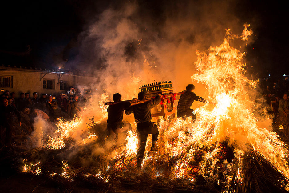 Men carrying a shrine jump over a bon fire, which means a wish for good luck during a traditional Chinese lunar New Year celebration in Jieyang, Guangdong province, China. PHOTO: REUTERS