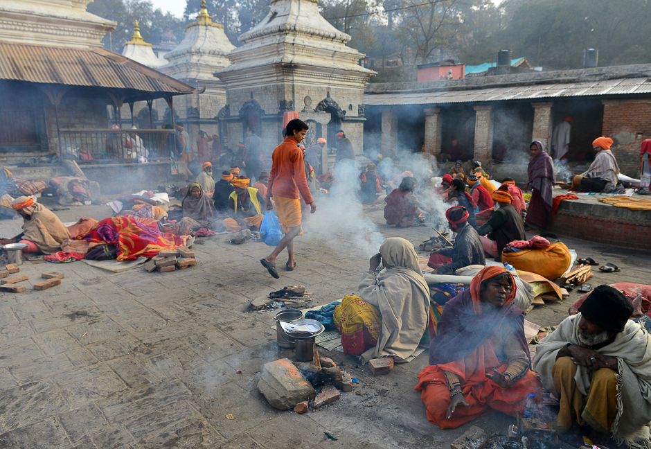 Nepalese Hindu devotees sit near the Pashupatinath temple on the eve of the Hindu festival Maha Shivaratri in Kathmandu. PHOTO: AFP