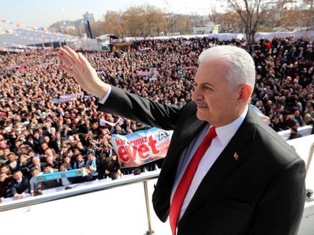 This handout photo released by the Turkish Prime Ministry Press office on February 25, 2017 shows Turkish Prime Minister and leader of the ruling Justice and Development (AK) party, Binali Yildirim greeting supporters, who wait outside, during a public meeting at Ankara's Arena to promote support for an April referendum on whether to boost the Turkish president's powers. PHOTO: AFP