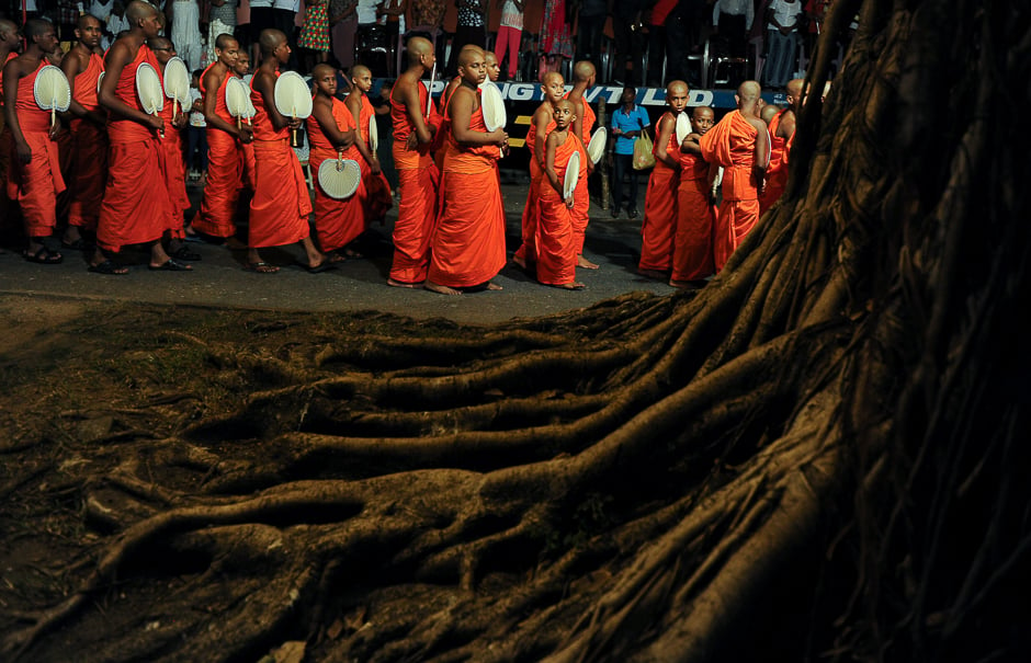 Monks take part in a procession in front of the Gangarama Temple during the Navam Perahera festival. PHOTO: AFP