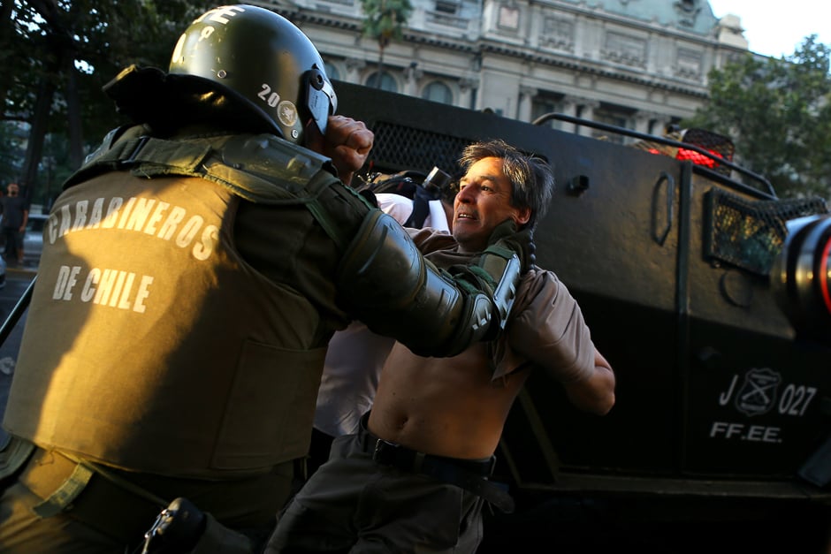 A riot policeman tries to detain a protester during a rally marking the anniversary of the death of union leader Juan Pablo Jimenez, in Santiago, Chile. PHOTO: REUTERS 