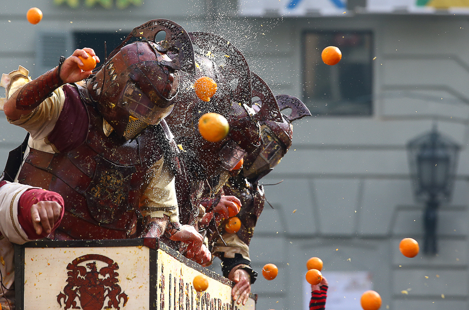 Members of a rival team are hit by oranges during an annual carnival orange battle in the northern Italian town of Ivrea. PHOTO: REUTERS