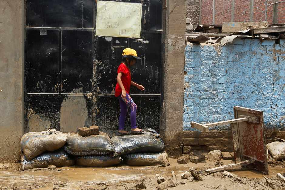 A child walks on a street after a landslide and flood in Lurigancho district in Chosica, Peru. PHOTO: REUTERS