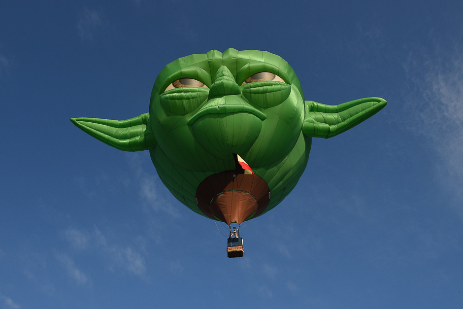 A hot air balloon in the likeness of Star Wars film character Yoda takes flight during the annual International Hot Air Balloon Festival at the former Clark US Air Force base in Pampanga province, north of Manila. PHOTO: AFP