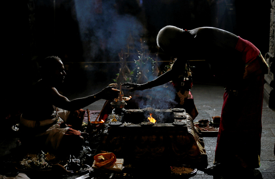 A Hindu priest makes a blessing for a devotee by praying and fasting for an entire day as they hold a night-long vigil at a Hindu temple in Colombo. PHOTO: REUTERS