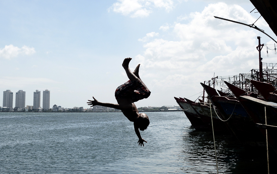 An Indonesian boy jumps into the sea from a pier at the main fishing port of Muara Angke to cool off in Jakarta. PHOTO: AFP