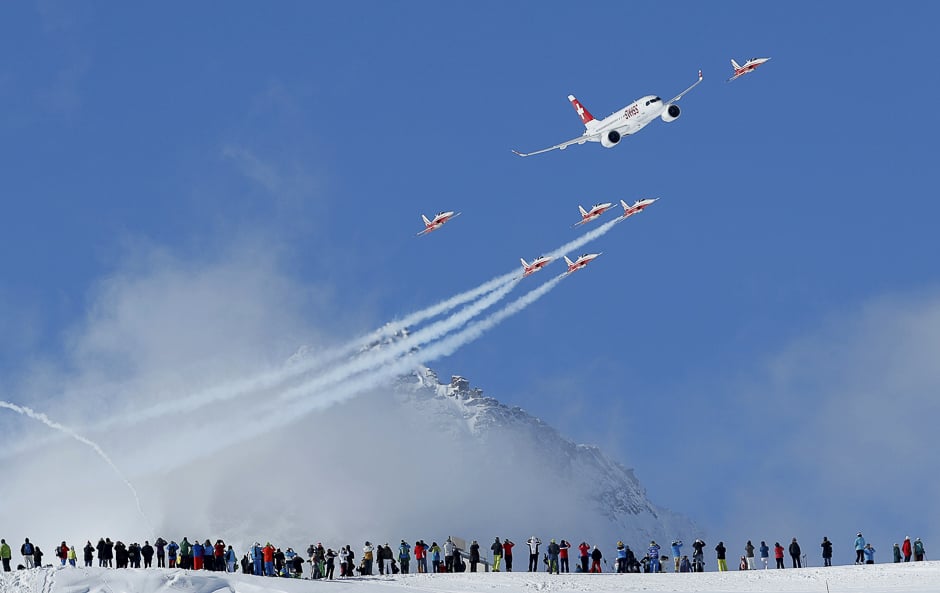 Members of the Swiss aerobatic team Patrouille Swiss fly in formation with a Swiss Bombardier CS100 over the men's Alpine Skiing World Championships in St. Moritz, Switzerland. PHOTO: REUTERS