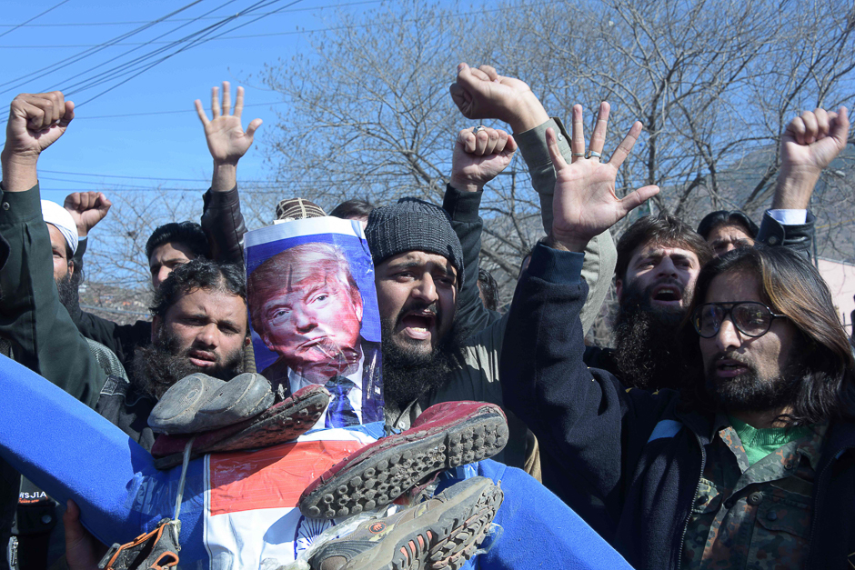 Pakistani demonstrators hold an effigy of US President Donald Trump and India Prime Minister Narendra Modi as they shout slogans during a protest after the Jamaat-ud-Dawa (JuD) organisation Hafiz Saeed was placed under house arrest in Muzaffarabad. PHOTO: AFP