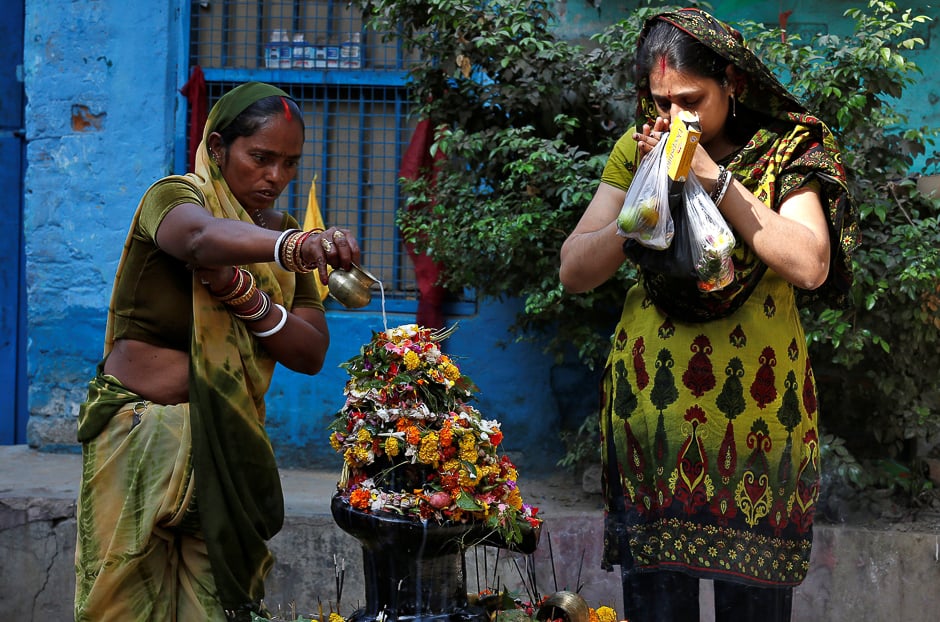 A Hindu devotee pours milk over a Shivling (a symbol of Lord Shiva) outside a temple in Kolkata, India. PHOTO: REUTERS