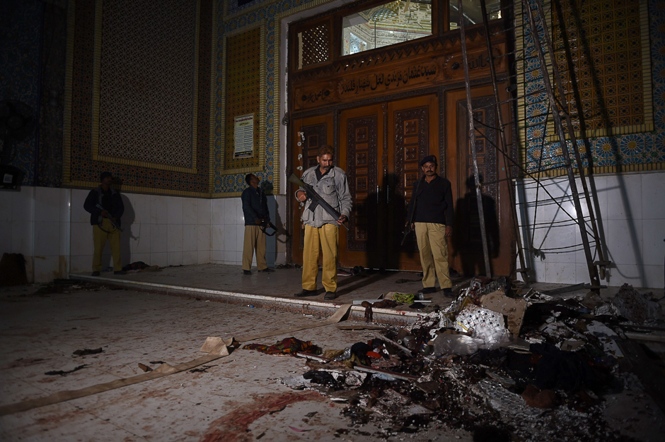 Pakistani security personnel stand guard a day after a bomb attack in the town of Sehwan. PHOTO: AFP