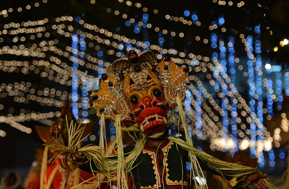 Sri Lankan traditional dancers perform in a procession in front of the Gangarama Temple during the Navam Perahera festival in Colombo. PHOTO: AFP
