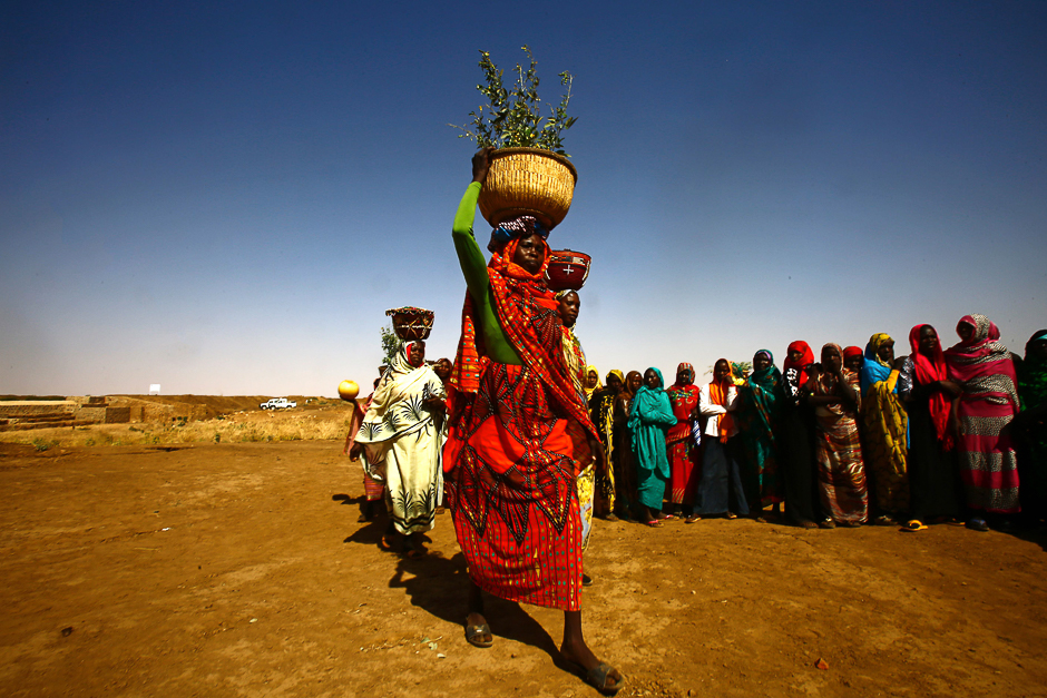Sudanese women walk carrying baskets about 60 kilometres north of El-Fasher, the capital of the North Darfur state. PHOTO: AFP