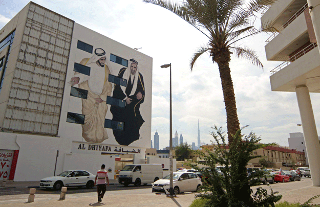 A picture taken on February 6, 2017 shows graffiti by Emirati muralist Ashwaq Abdullah, paying homage to founders of the United Arab Emirates, sheikhs Rashed Al Maktoum and Zayed Al Nahyan, on a wall of Dubai's 2nd of December street, which is part of the government-funded Dubai Street Museum project. PHOTO: AFP