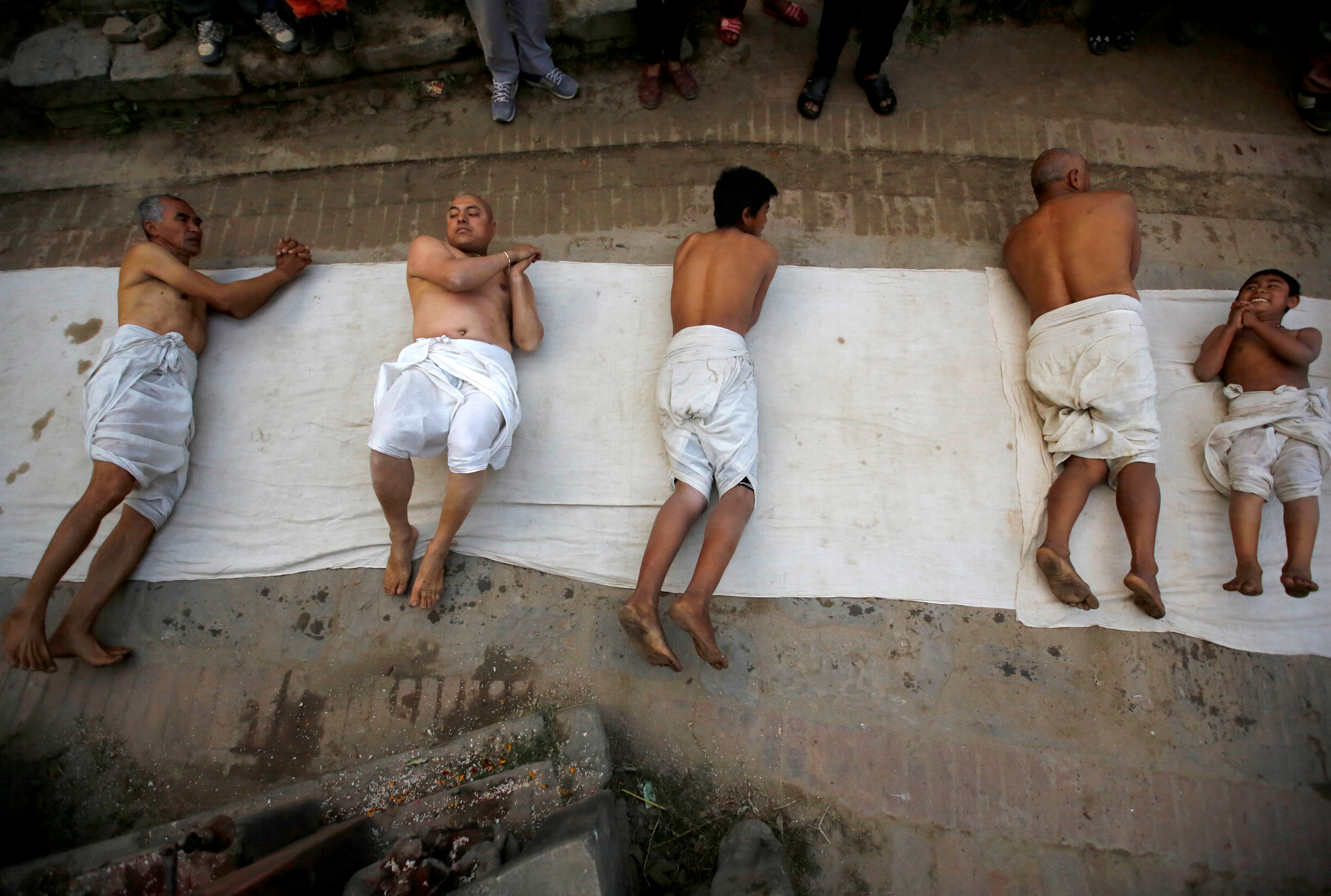 Devotees offer prayers by rolling on the street during the Swasthani Brata Katha festival in Bhaktapur, Nepal January 13, 2017. REUTERS/Navesh Chitrakar