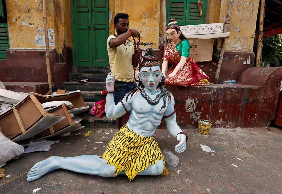 An artisan adorns an idol of Hindu Lord Shiva, which will be used to decorate a pandal, or a temporary platform, ahead of the Hindu festival of Maha Shivaratri in Kolkata. PHOTO: REUTERS