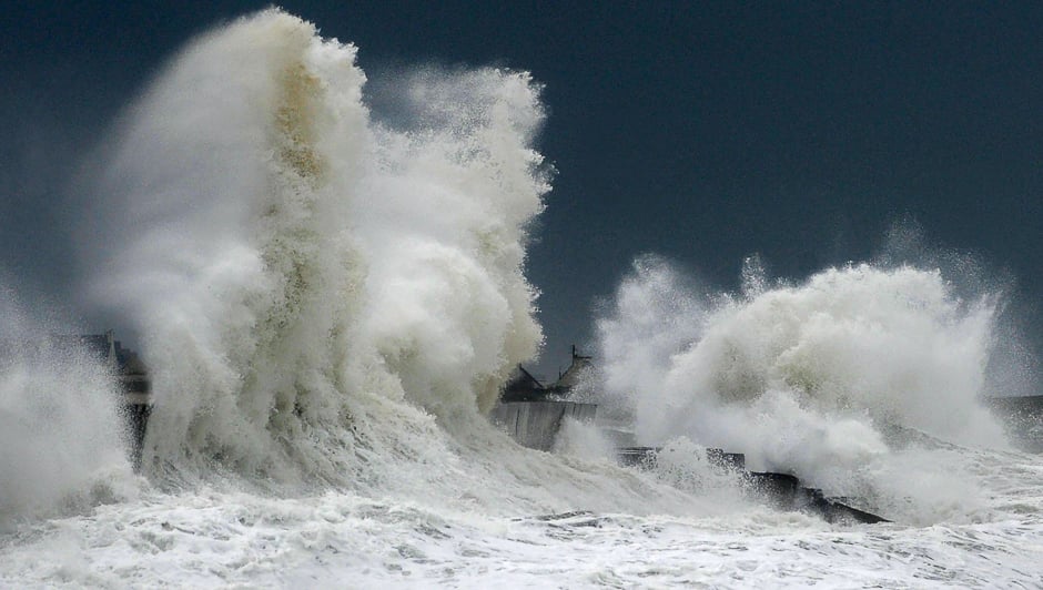 Huge waves break on a harbour wall at the port of Lesconil, western France. PHOTO: AFP