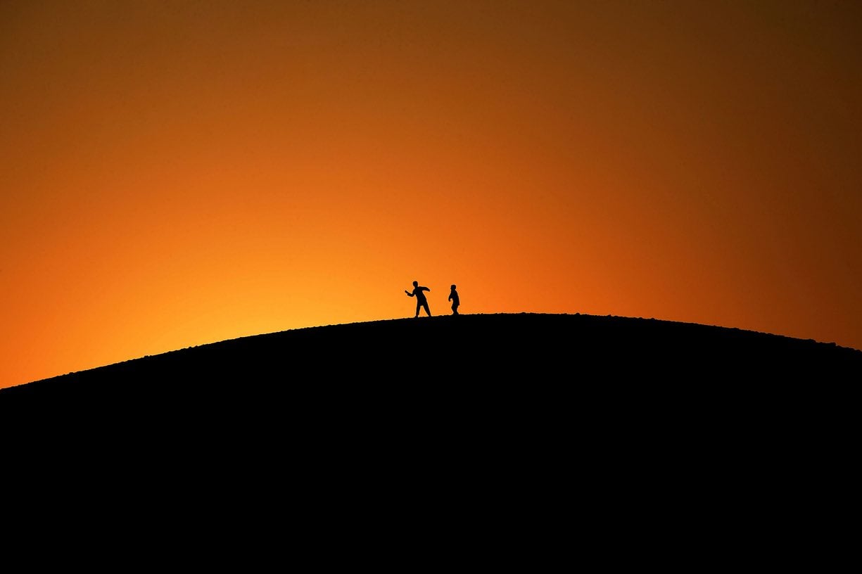Youngsters play on a hilltop as the sun sets, Jalalabad, Afghanistan. PHOTO: AFP
