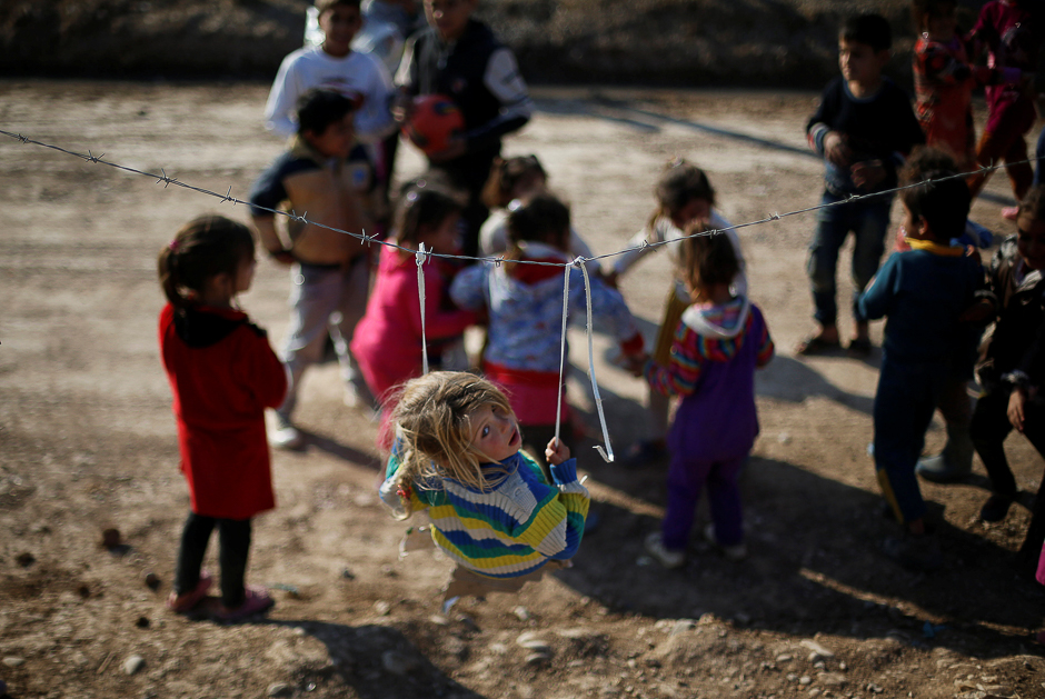 Displaced Iraqi children who fled the Islamic State stronghold of Mosul with their families play at Khazer camp, Iraq. PHOTO: REUTERS