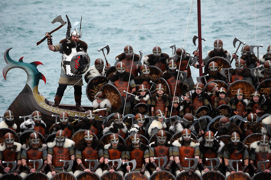 Participants dressed as Vikings pose by a long boat in the annual Up Helly Aa festival in Lerwick, Shetland Islands. PHOTO: AFP