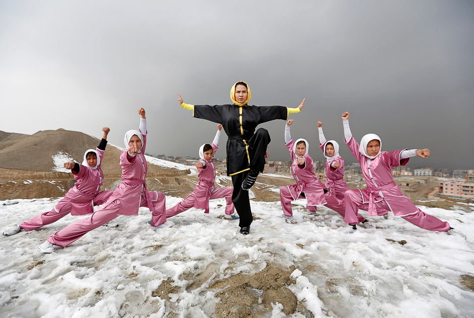 Sima Azimi (C), 20, a trainer at the Shaolin Wushu club, poses with her students after an exercise on a hilltop in Kabul. PHOTO: REUTERS