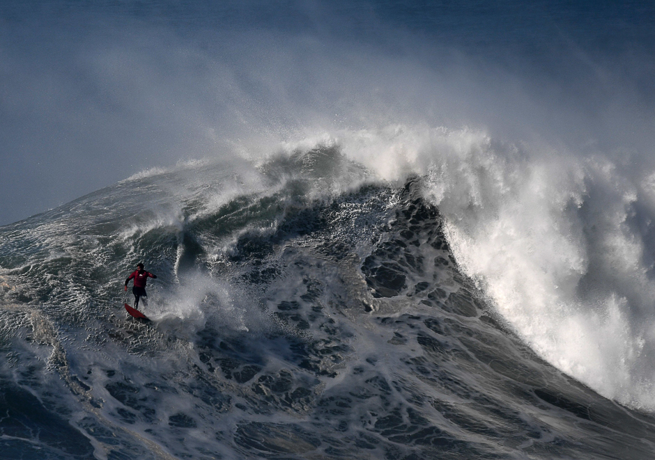 Chilean big wave surfer Rafael Tapia drops a wave during a surf session off Praia do Norte in Nazare. PHOTO: AFP