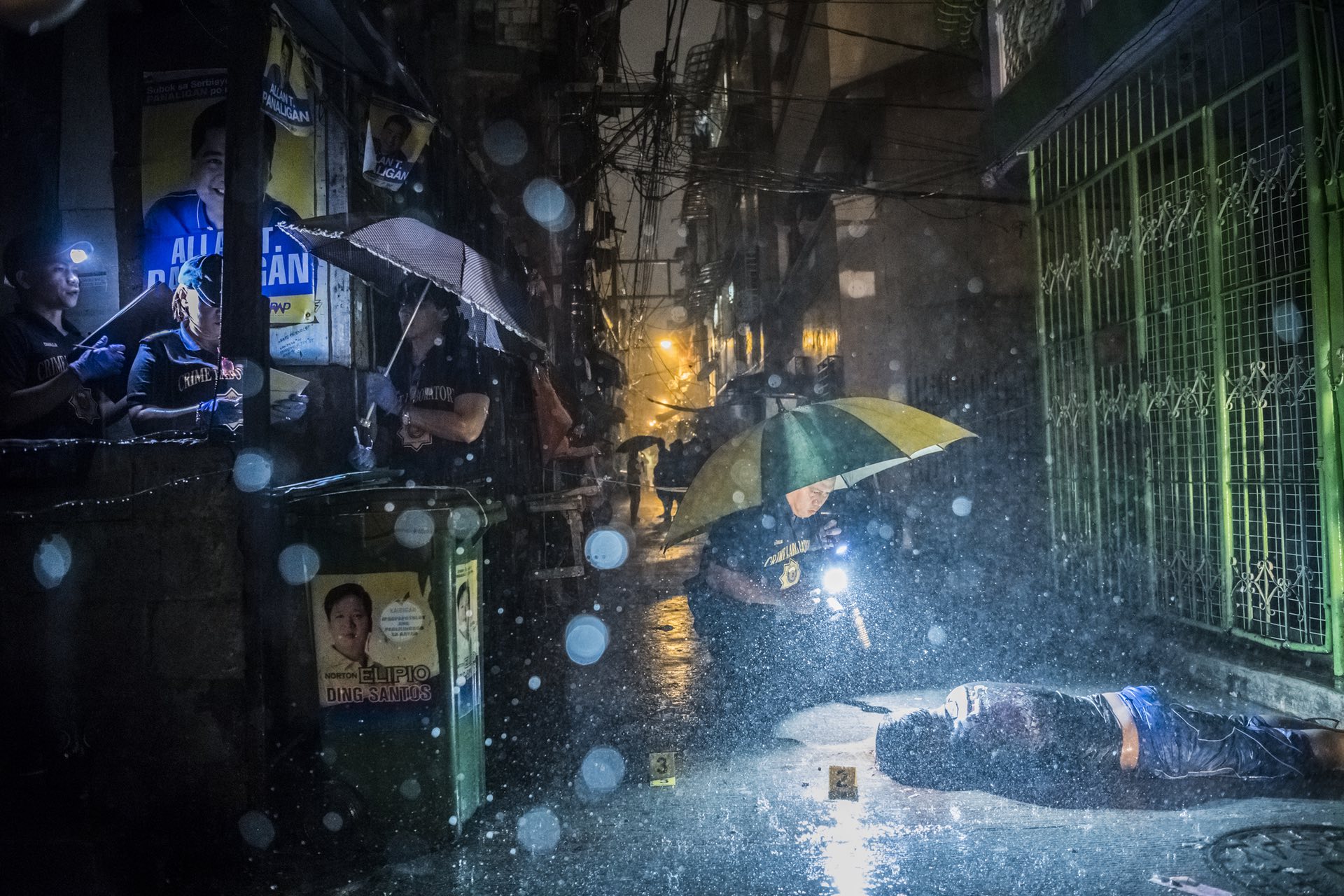 General news â stories, first prize Police inspect an alley where a victim was killed by two unidentified gunmen in Manila, Philippines Photograph: Daniel Berehulak/AP