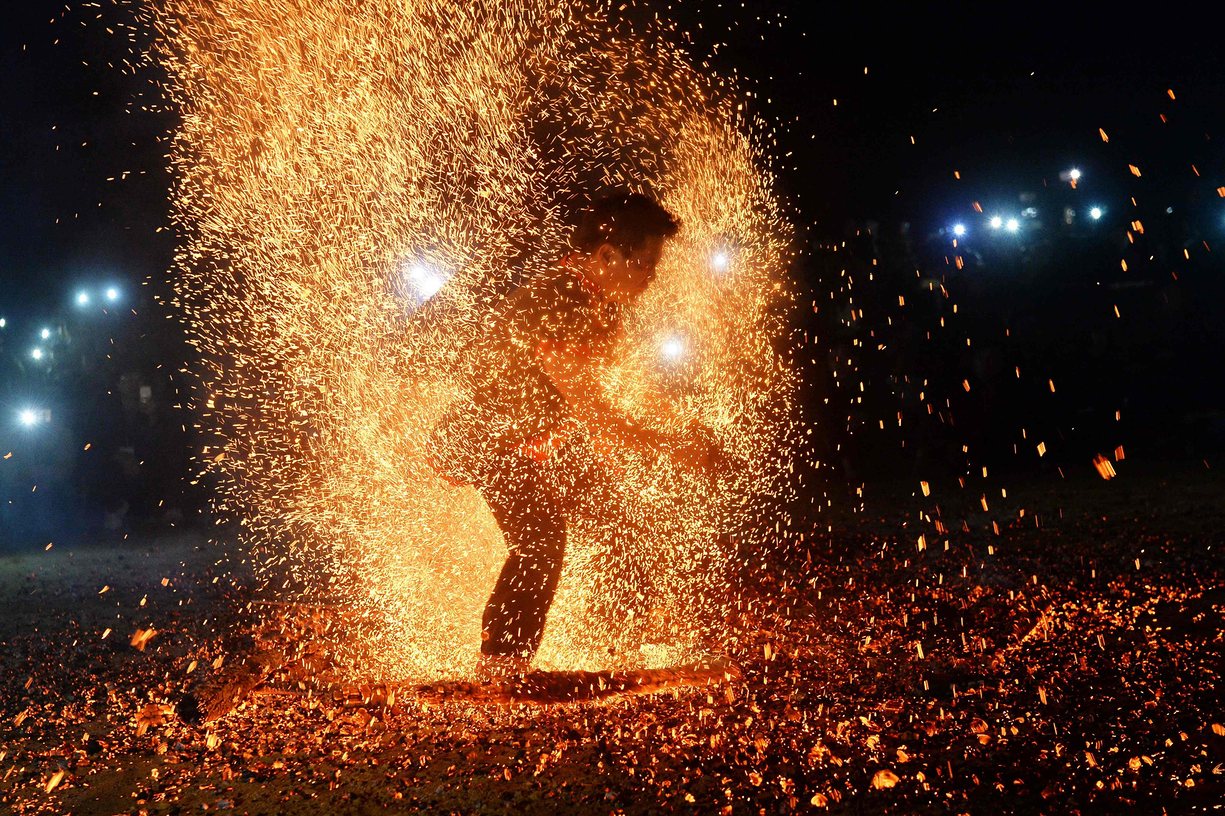 A Pa Then dancer performs a fire dance at a spring festival. The ritual, to exorcise spiritual demons and pray for a healthy harvest, was formerly banned by communist authorities. The Pa Then ethnic minority now perform the fire dance publicly after decades of celebrating in the woods in secret, Lam Binh, Vietnam. PHOTO: AFP