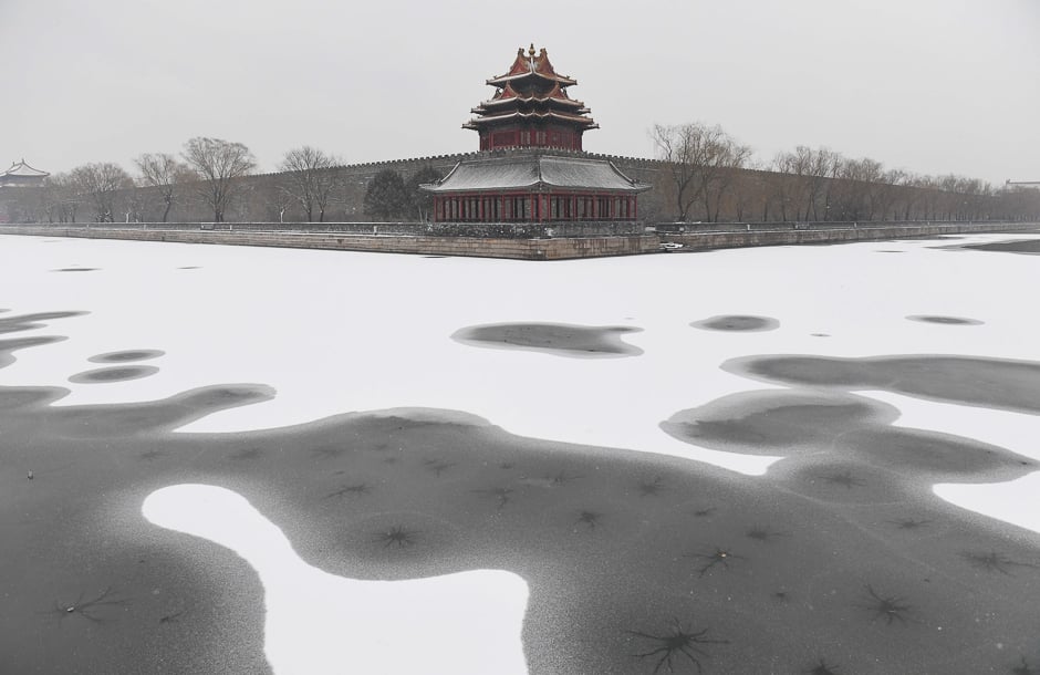 Snow is seen in the moat surrounding the Forbidden City during a snowfall in Beijing. PHOTO: AFP