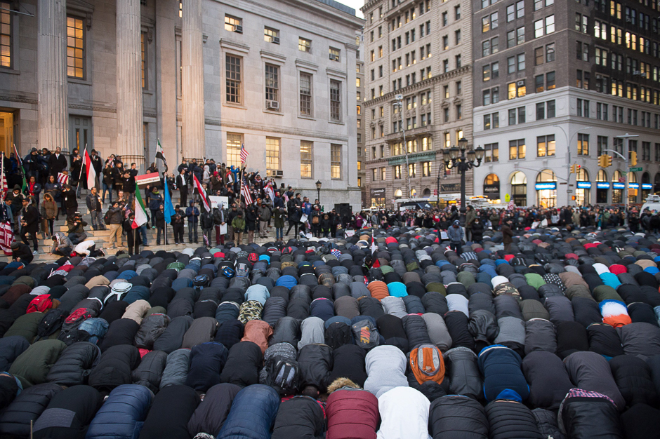 People gather for evening prayer at a rally at Brooklyn Borough Hall as Yemeni bodega and grocery-stores shut down to protest US President Donald Trump's Executive Order banning immigrants and refugees from seven Muslim-majority countries, including Yemen in New York. PHOTO: AFP