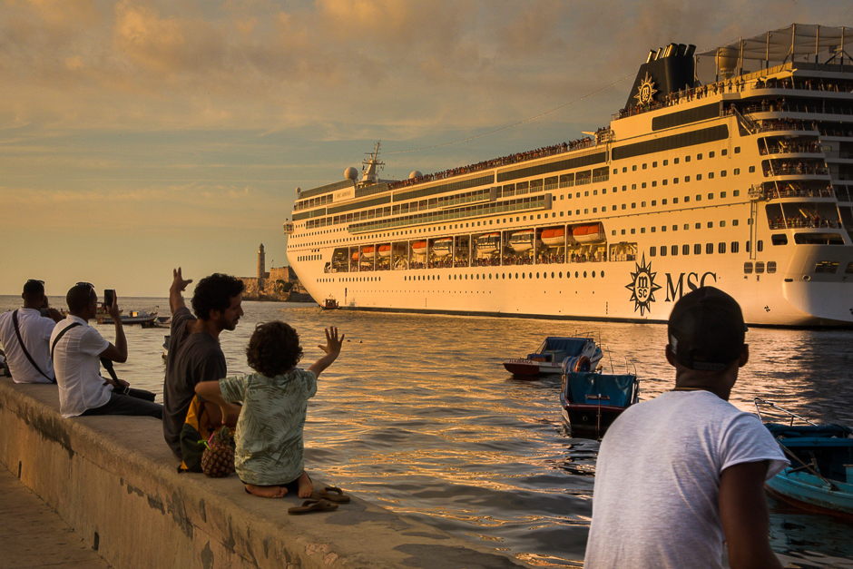 People wave as a cruise ship leaves Havana's harbour. PHOTO: AFP