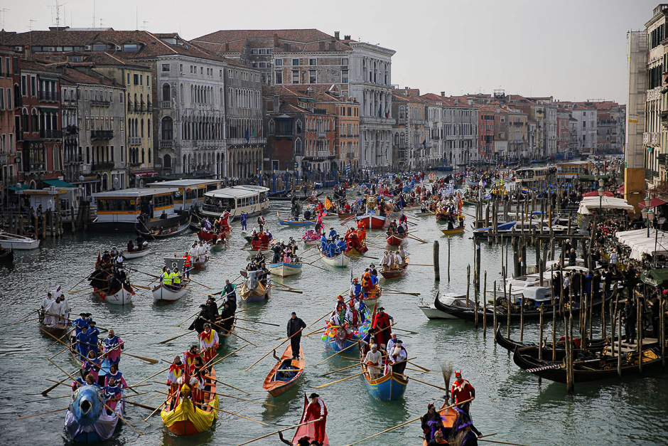 People row during the masquerade parade on Grand Canal during Venice Carnival in Venice. PHOTO: AFP